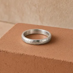 Hammered silver ring on a terracotta plaster block