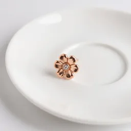 Pair of unbranded pearl drop earrings in a small white dish