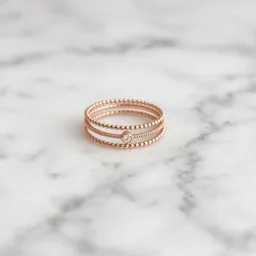 Unbranded rose-gold stacking rings on marble