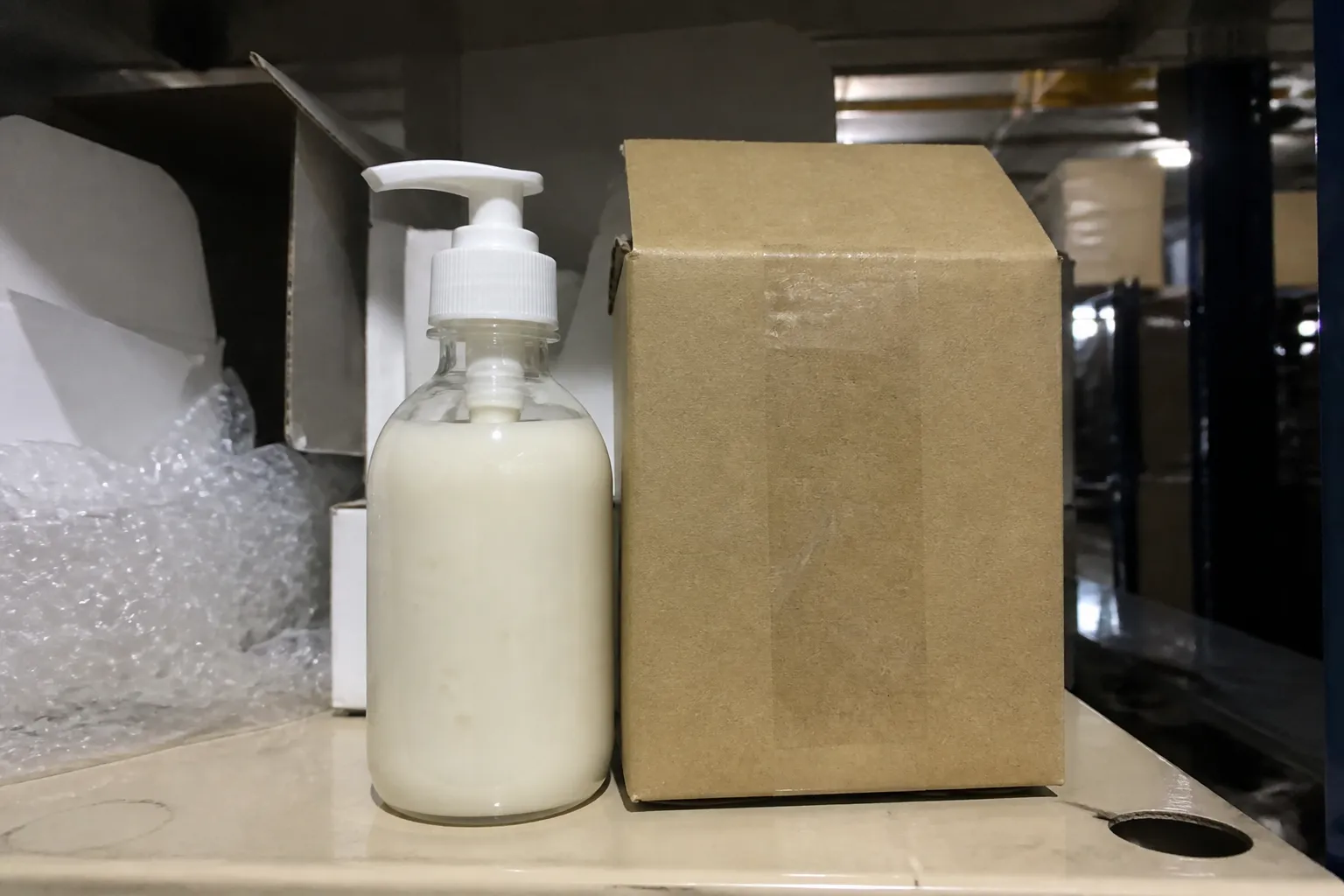 Supplier-style product photo beside packaging on a warehouse shelf